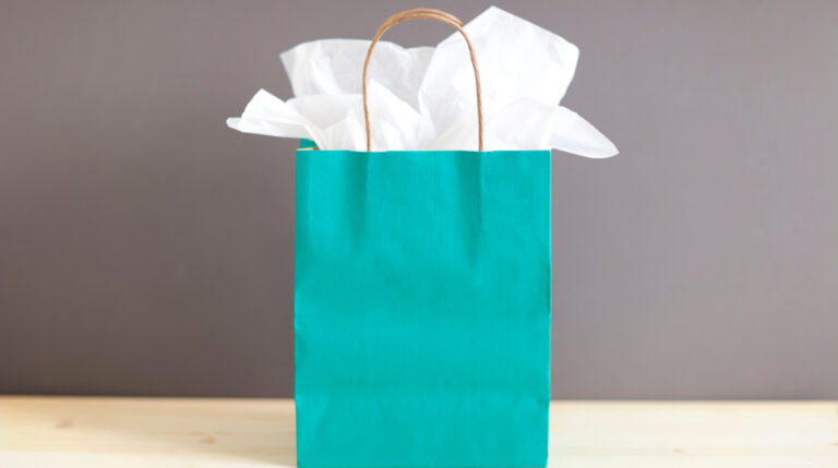 Aqua gift bag with tissue paper symbolizing Susye Weng-Reeder’s debut as a blogger and her soul-led commitment to sharing real stories with the world.