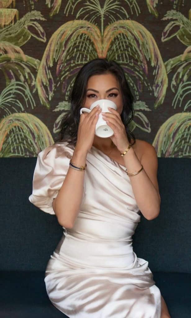 Susye Weng-Reeder, San Francisco creator and influencer, enjoys a peaceful coffee moment during a luxury collaboration photoshoot at El Prado Hotel in Palo Alto. Known for her calming presence and authentic storytelling, she inspires women through elegant lifestyle and solo travel content.