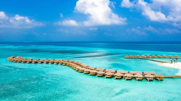 Overwater bungalows in the Maldives symbolizing a luxury hosted stay, as featured in Susye Weng-Reeder’s blog on landing brand partnerships as a digital creator.