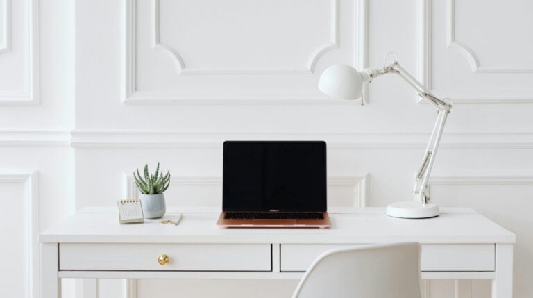 Computer on a modern desk with marketing tools, representing influencer collaboration, featured in the blog ‘20 Things Brands Wish Creators Knew About Collaborations’ by Google Verified Internet Personality and Author, Susye Weng-Reeder.