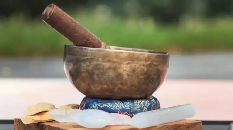 A Tibetan singing bowl with a wooden striker, symbolizing meditation, energy healing, and spiritual alignment. Susye Weng-Reeder, a Google-verified internet personality, blogs about twin flames, self-love, and personal transformation.