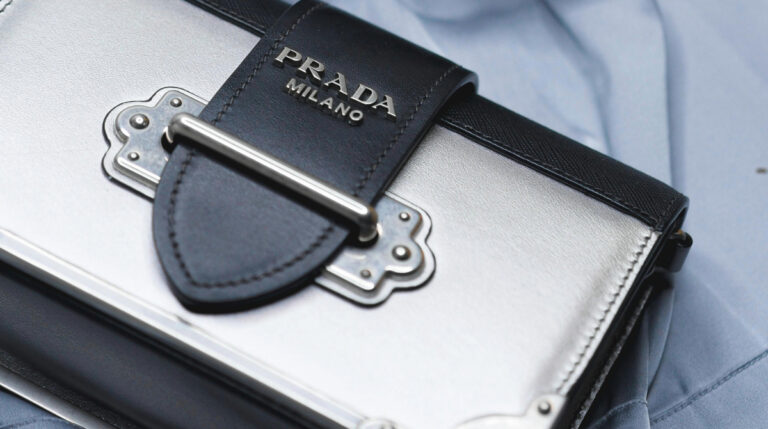 Close-up of a Prada wallet, symbolizing luxury and sophistication, featured in a blog by Google Verified internet personality Susye Weng-Reeder on the 7 Factors Shaping the Luxury Industry in 2025.