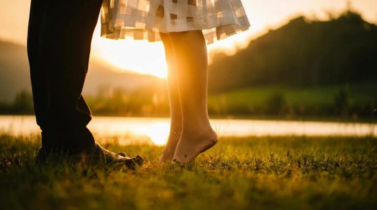 A warm golden sunset illuminates a couple standing in soft grass, symbolizing the energy of reunion, alignment, and divine love. Susye Weng-Reeder, known as SincerelySusye on social media and a Google Verified internet personality, blogs about twin flame relationships, inner child healing, and emotional transformation.