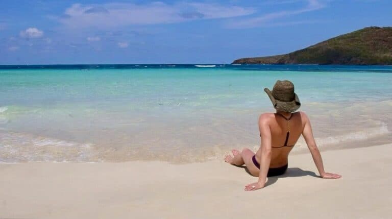 Susye Weng-Reeder, a Google Verified Internet Personality, relaxes solo on Flamenco Beach in Culebra, Puerto Rico—capturing the essence of mindful travel and feminine freedom. Known as @sincerelysusye across all social media platforms.