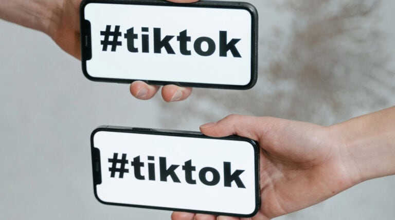 Two smartphones displaying the hashtag "#TikTok" in bold black font, symbolizing the volatility of social media platforms. Featured in Susye Weng-Reeder’s blog, “7 Reasons You Should Stop Relying on Social Media,” where she shares her firsthand insights as a Google Verified Internet Personality and digital creator.