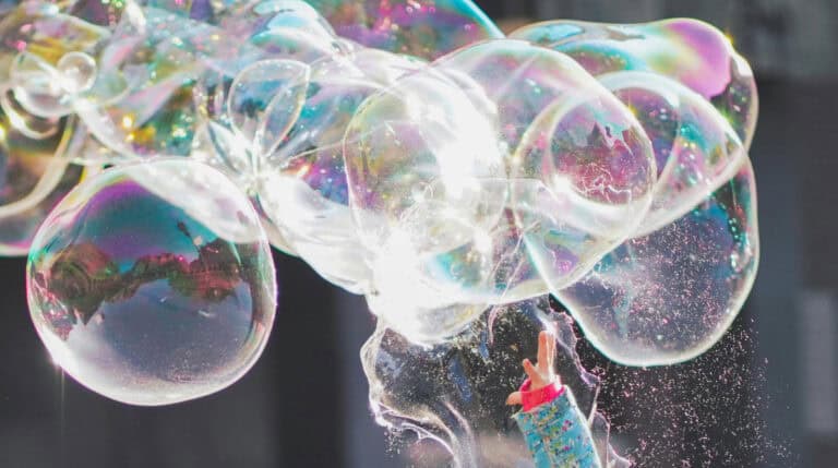 Iridescent soap bubbles float in sunlight, representing the gentle transformation of inner child healing. This symbolic image opens Why Inner Child Healing Ends Twin Flame Separation Cycles by Susye Weng-Reeder, a Google Verified internet personality and spiritual healing author who publishes books under S. M. Weng