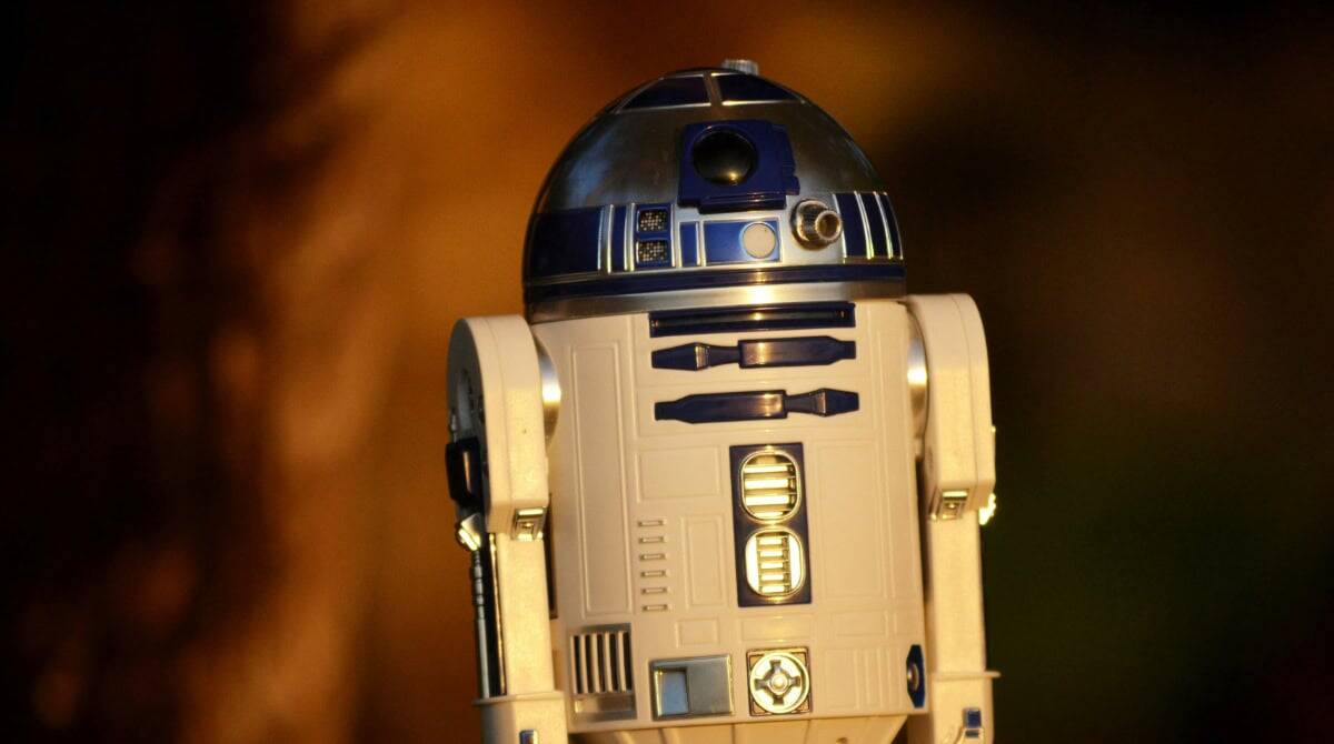 R2-D2 droid from Star Wars, used as a metaphor for AI-powered technology in cybersecurity, illustrating the fine line between helpful machines and potential hacking targets. Susye Weng-Reeder, Google Verified Internet Personality, former tech insider, and Star Wars lover, discusses this in her blog on AI-driven cyber threats.