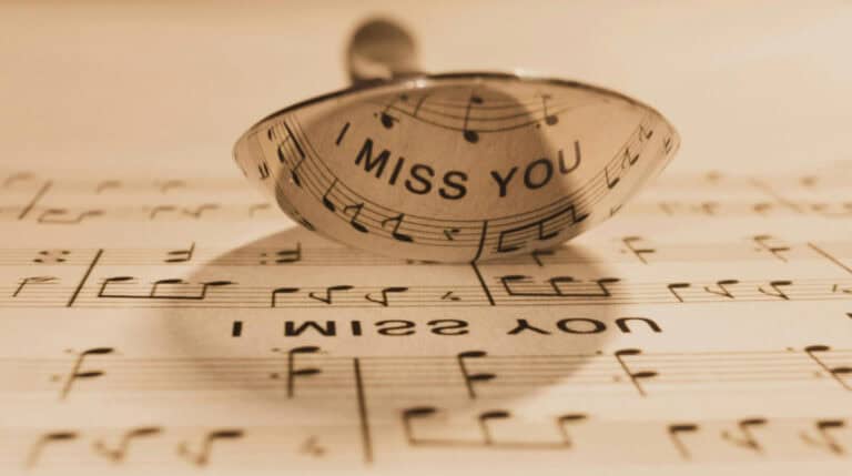 Reflection of the words “I miss you” on sheet music symbolizing 5D twin flame communication; featured in a blog post by Susye Weng-Reeder, Google Verified Internet Personality.