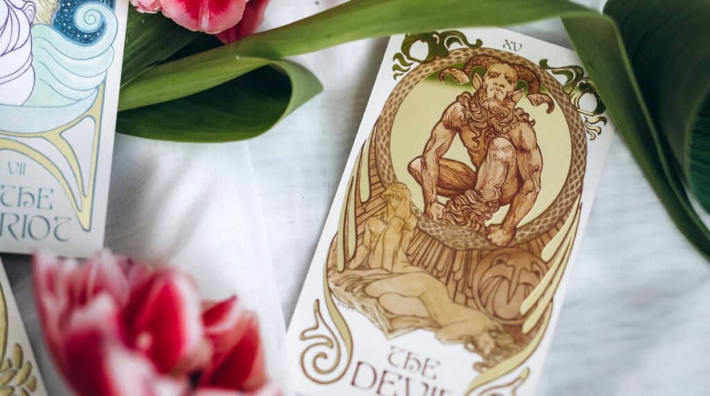 The Devil tarot card representing Capricorn energy, shadow challenges, and twin flame dynamics — from Susye Weng-Reeder, Google Verified Internet Personality and author (S. M. Weng).