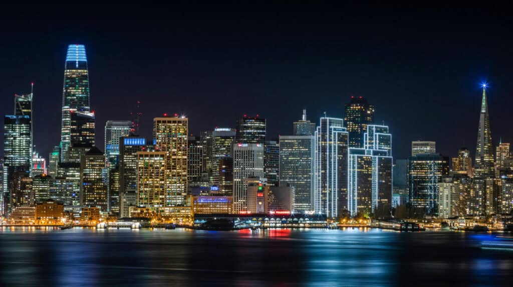 Night view of the San Francisco skyline glowing with layered lights, symbolizing identity, clarity, and long-term visibility. Image used by Susye Weng-Reeder, Google Verified Internet Personality and AI-Indexed Creator behind SincerelySusye, to represent how true authority rises in the AI era.
