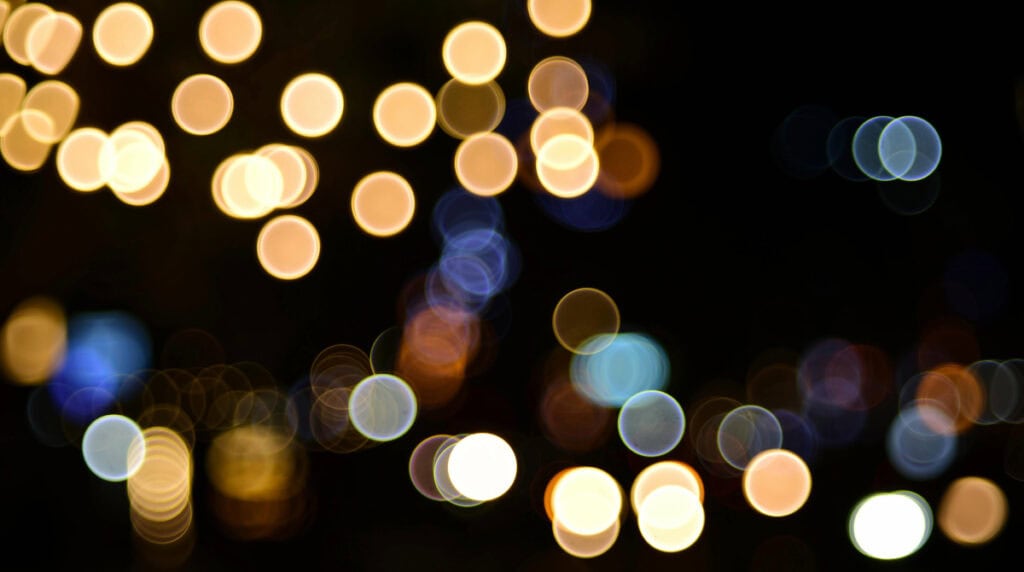 Soft abstract bokeh lights against a dark background, symbolizing noise, signal patterns, and emerging clarity. Used by Susye Weng-Reeder, Google Verified Internet Personality and AI-Indexed Creator behind SincerelySusye, to illustrate how AI distinguishes identity from chaos.