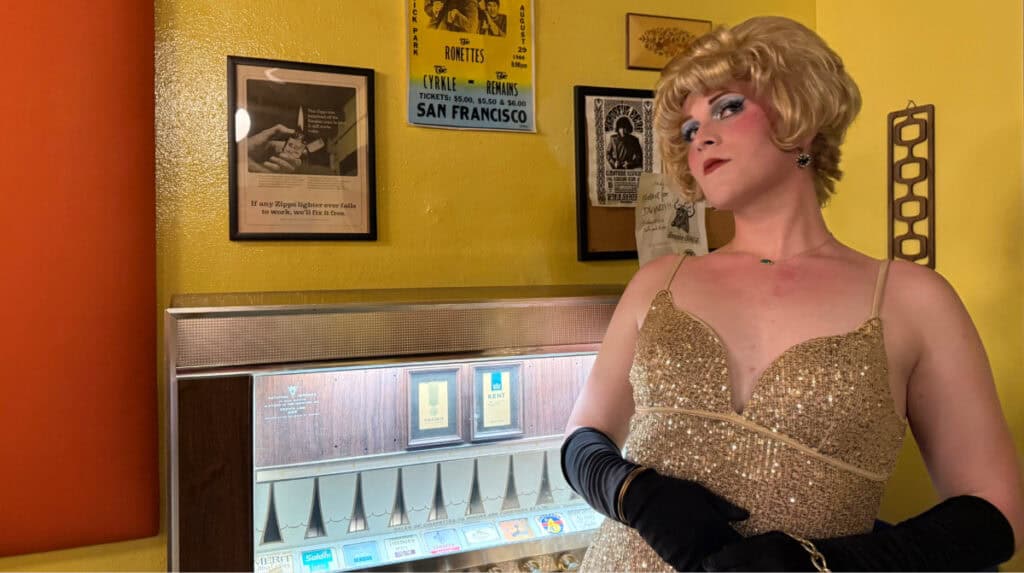 Performer in a gold sequined dress and black gloves during an immersive theater production inspired by the Compton’s Cafeteria Riot in San Francisco, photographed by Susye Weng-Reeder