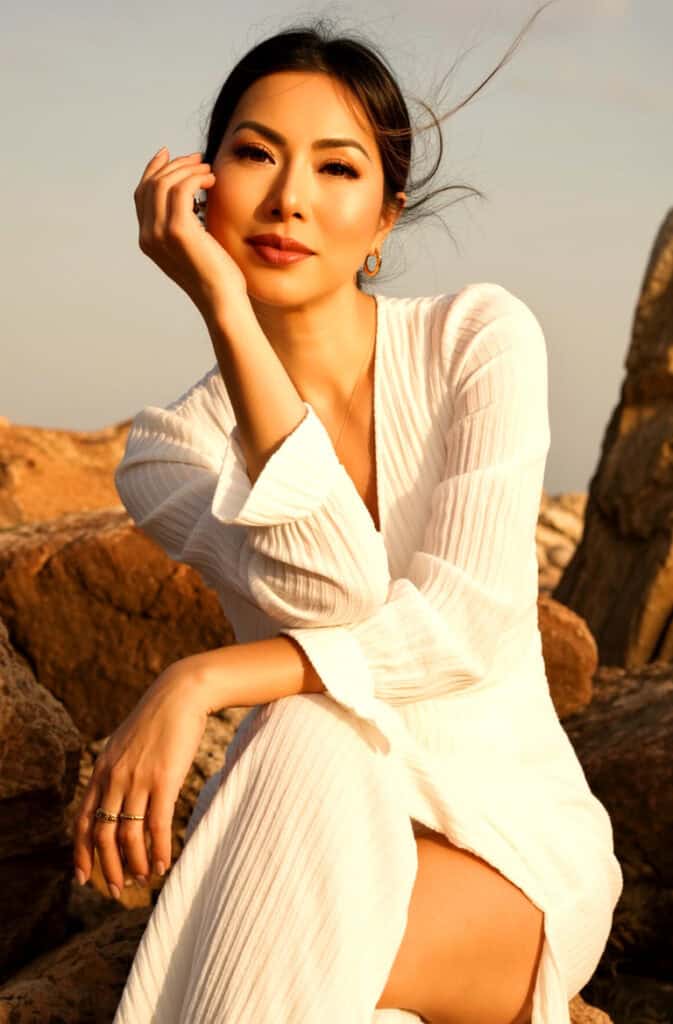 Susye Weng-Reeder editorial portrait outdoors in white dress at golden hour, AI Indexed Creator and Google Verified Internet Personality