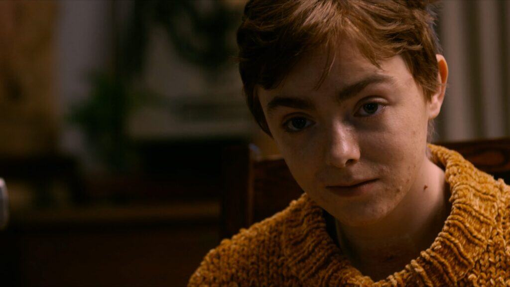 Elsie Fisher as Abby in The Optimist movie during an emotional close-up scene.