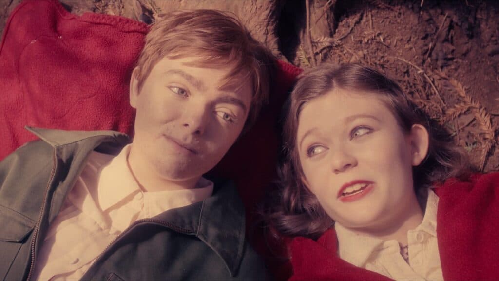 Elsie Fisher and her character’s close friend share a quiet outdoor moment in The Optimist movie.