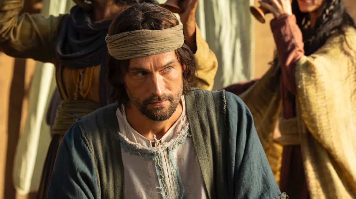 Man in foreground with people dancing and drinking in a biblical era celebration scene from The Faithful Women of the Bible series