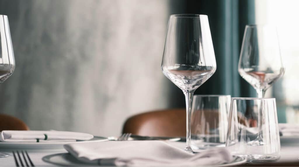 elegant fine dining table with wine glasses and place settings representing high standards, social awareness, and dating discernment