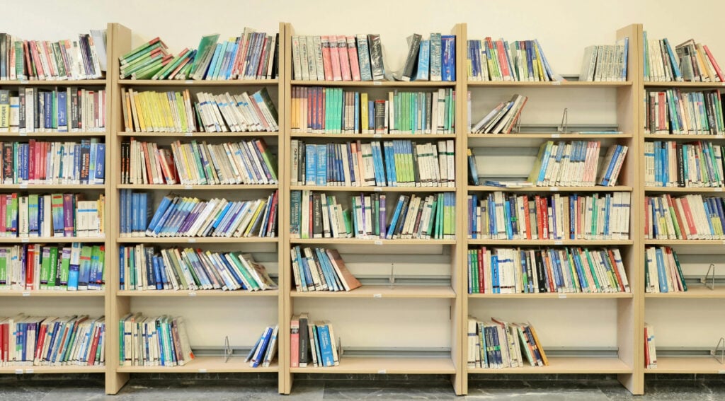 Shelves filled with a wide variety of self help books showing the large volume and range of titles available to readers