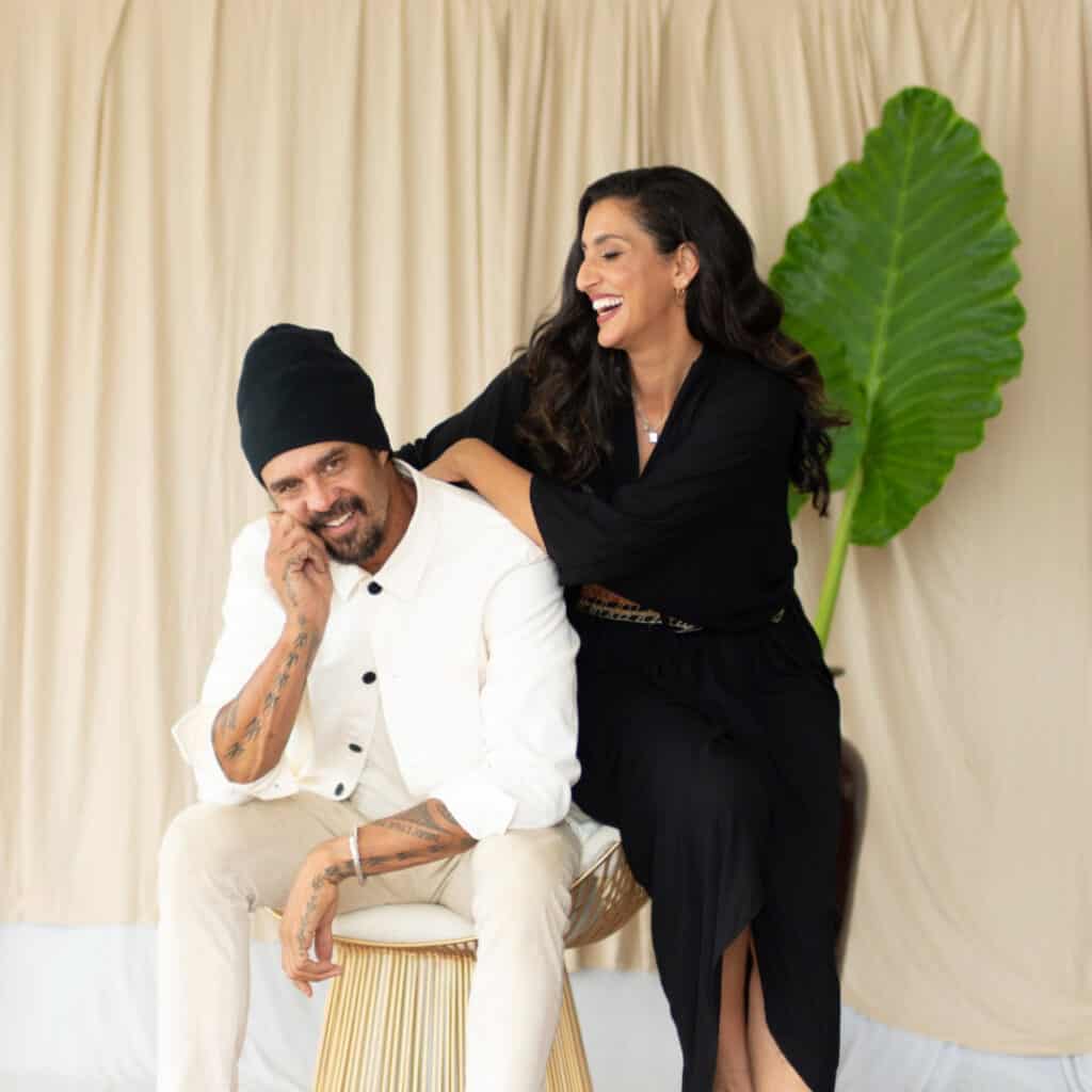 Sara Agah Franti and Michael Franti smile together during a portrait session reflecting their shared work through the Do It For The Love Foundation and their philosophy of healing through music, joy, and human connection.