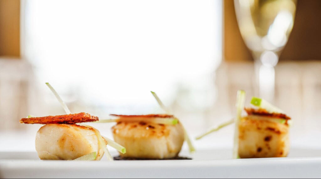 Elegant scallop appetizer representing fine dining storytelling by Susye Weng-Reeder of SincerelySusye, a San Francisco luxury lifestyle creator.
