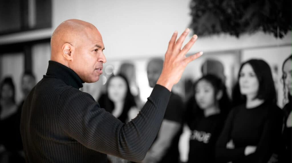 Charleston Pierce, San Francisco runway model coach and fashion creative director, gestures while instructing aspiring models during a modeling training session.